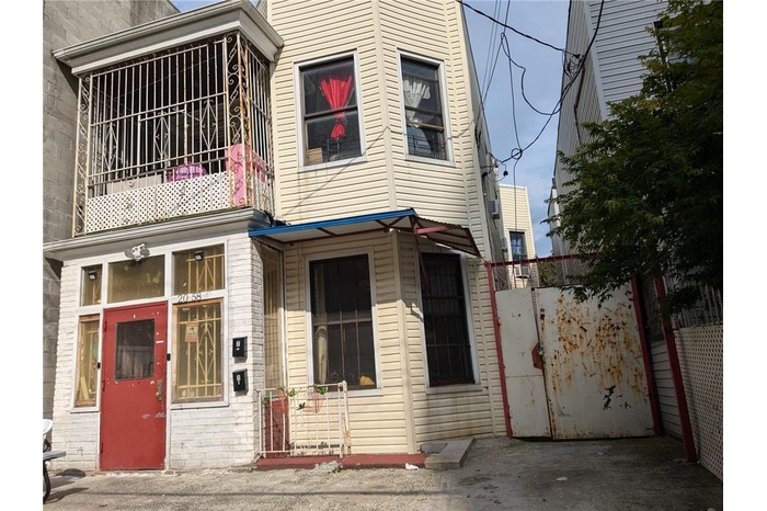 View of front of property with a balcony