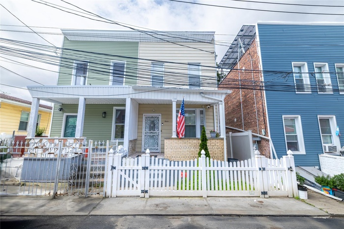 View of front of house with covered porch, a gate, and a fenced front yard
