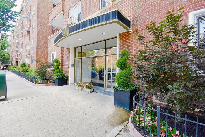 Doorway to property featuring brick siding