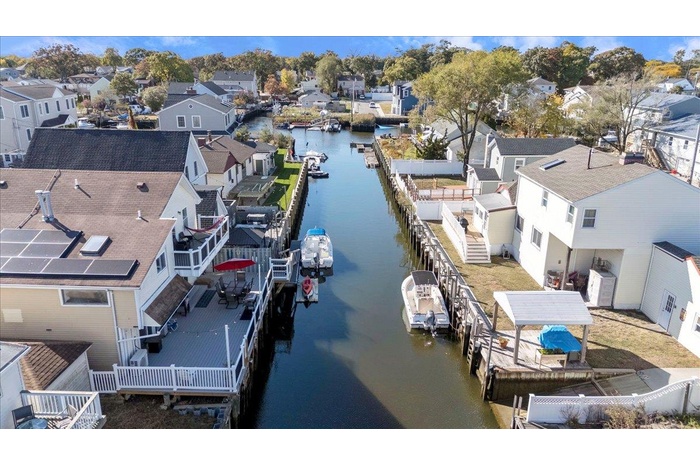 Birds eye view of property featuring a water view and a residential view