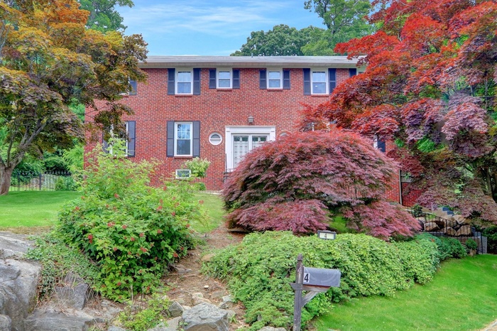 Colonial-style house with brick siding