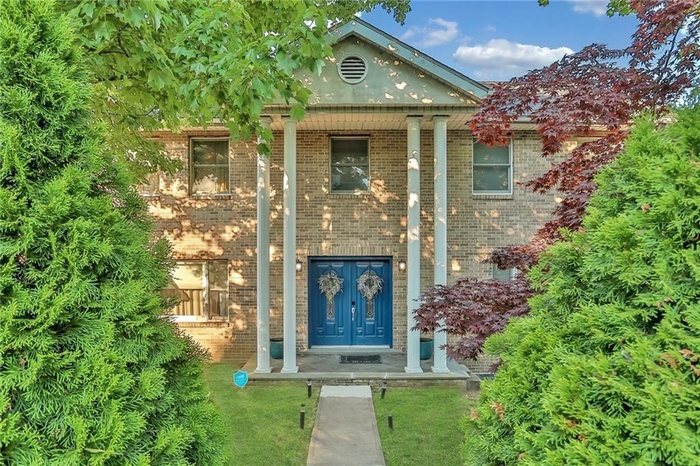 View of exterior entry with brick siding