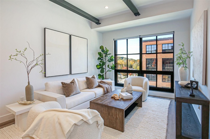 Living room featuring beamed ceiling, wood finished floors, and recessed lighting