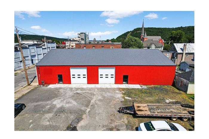 front of building, can see new roof, showing partial parking.
