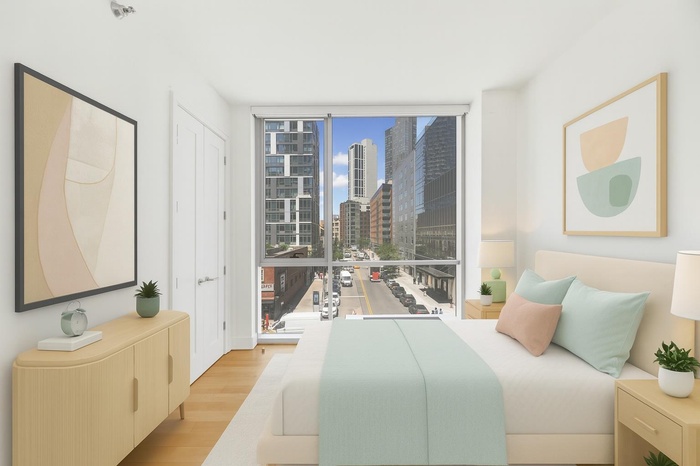 Bedroom with a skyline view, wood finished floors, and expansive windows