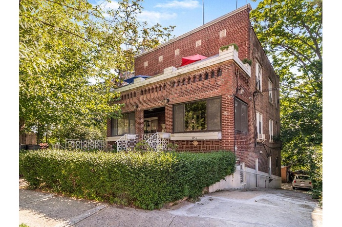 Street side view of front facade with driveway entrance
