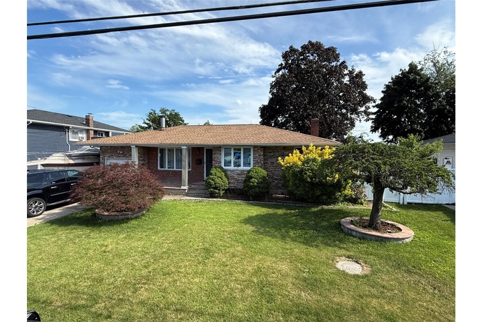 View of front of property featuring a front lawn and a chimney