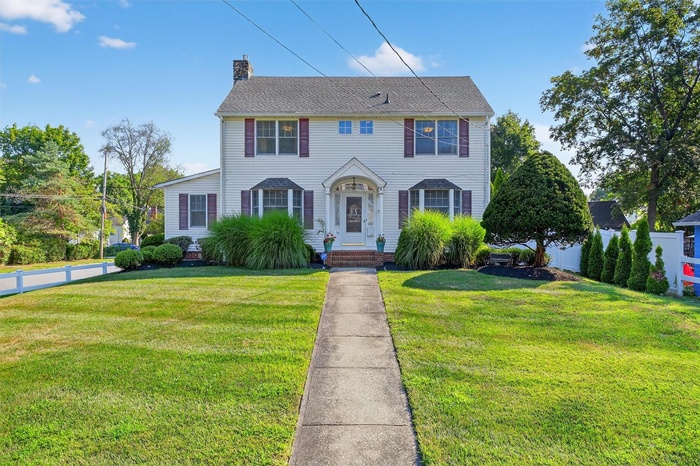 Colonial inspired home featuring a chimney