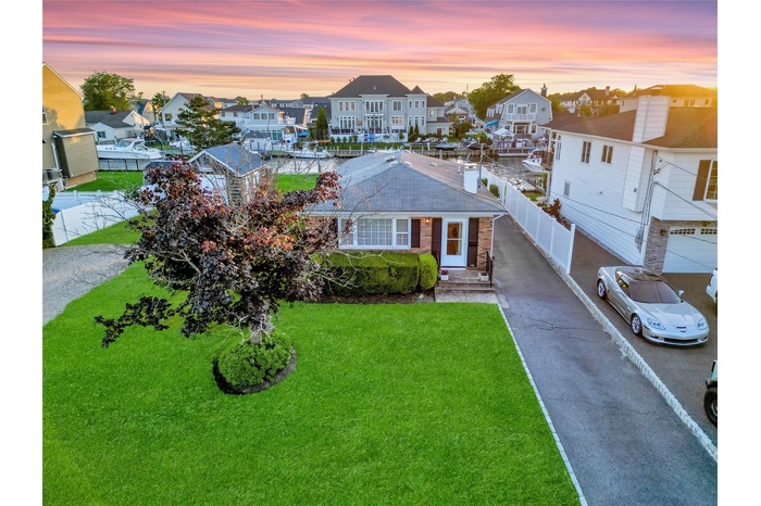 Single story home featuring a residential view and a shingled roof