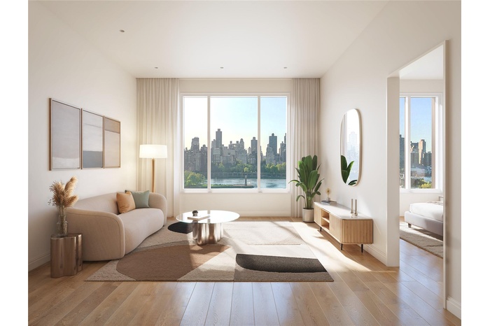 Living area featuring healthy amount of natural light, light wood-style flooring, and a view of skyline