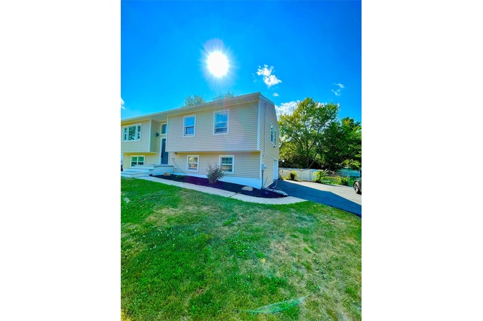 Split foyer home with driveway and a garage