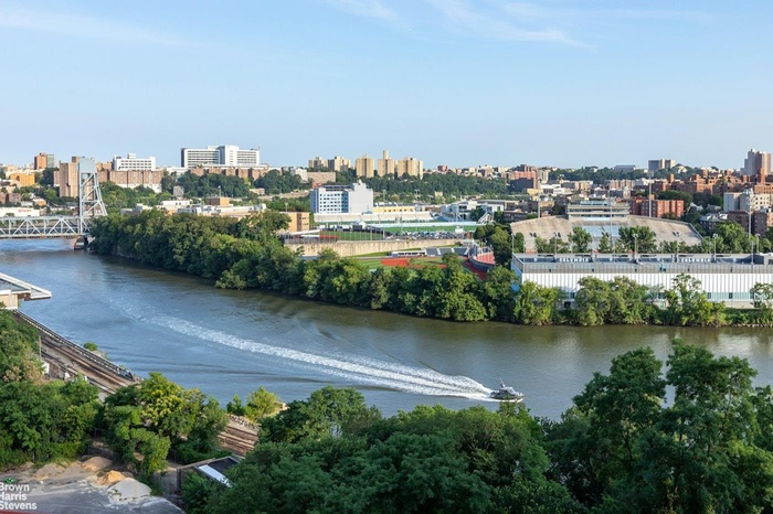 Water view featuring nearby urban area and a notable bridge