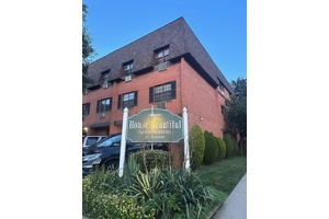 This charming three story brick building in a sought after Bayside neighborhood offers a prime location near transit, schools, shopping, dining, and parks.