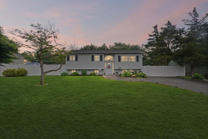 Bi-level home with asphalt driveway