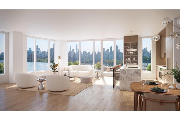 Living area with light wood-style floors, a water view, and a view of skyline