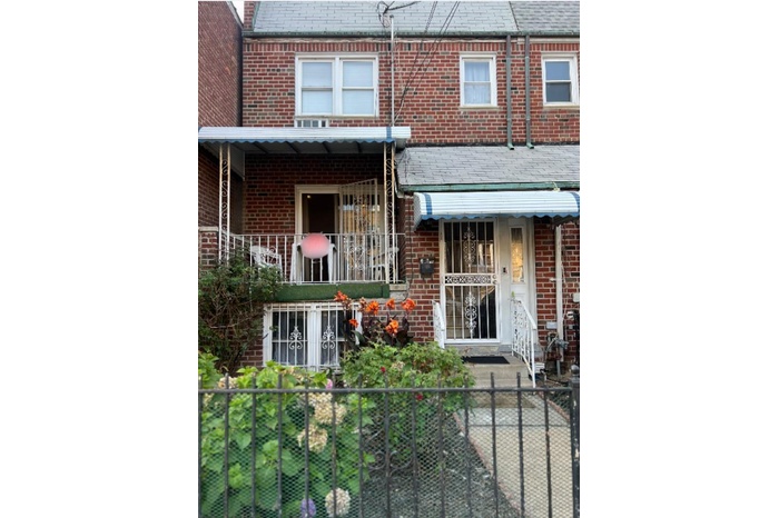 View of front of property featuring brick siding and a high end roof