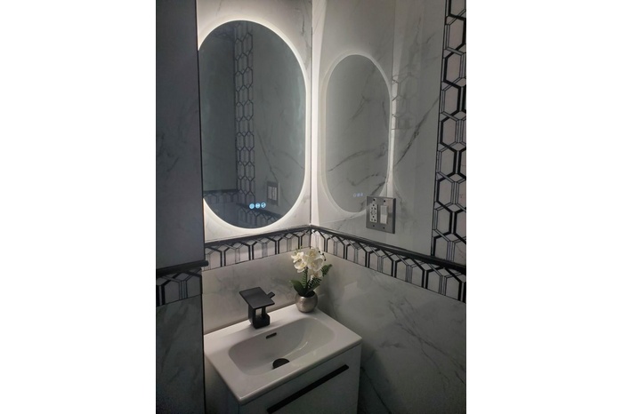 Bathroom featuring vanity and tile walls