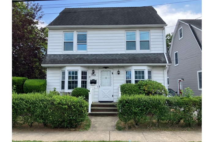 View of front of home with a shingled roof