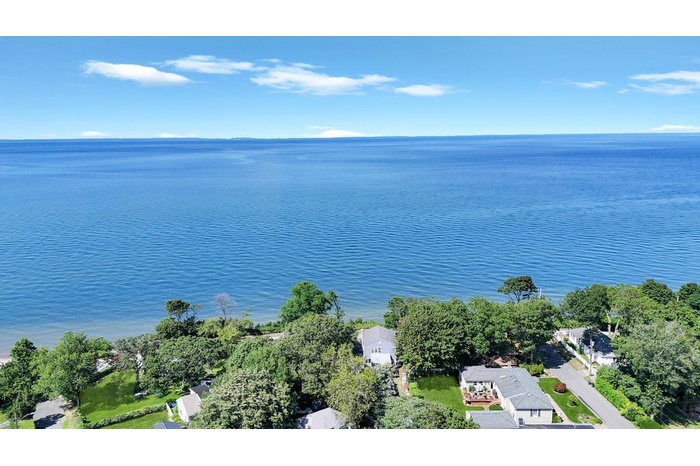 Aerial view of property's location with a nearby body of water