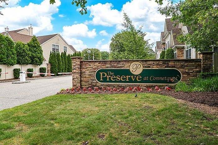 Community / neighborhood sign featuring a yard