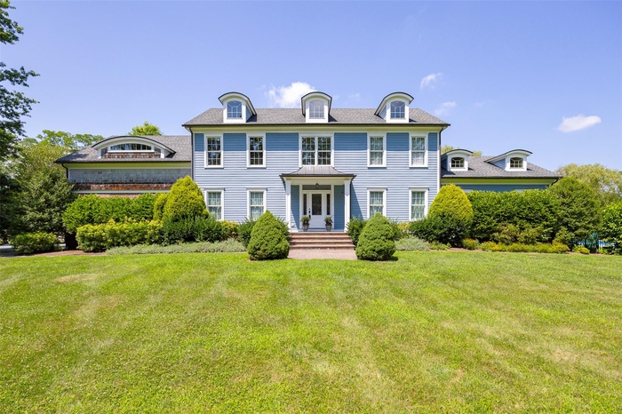 Colonial inspired home with a front lawn