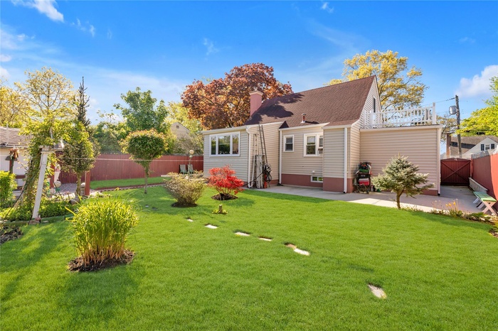 Rear view of property with a patio and a chimney