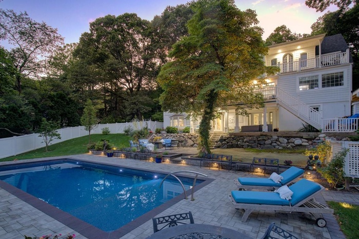 View of pool featuring stairway, a fenced backyard, and a patio area