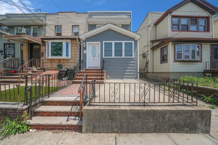 Townhome / multi-family property featuring a fenced front yard and entry steps