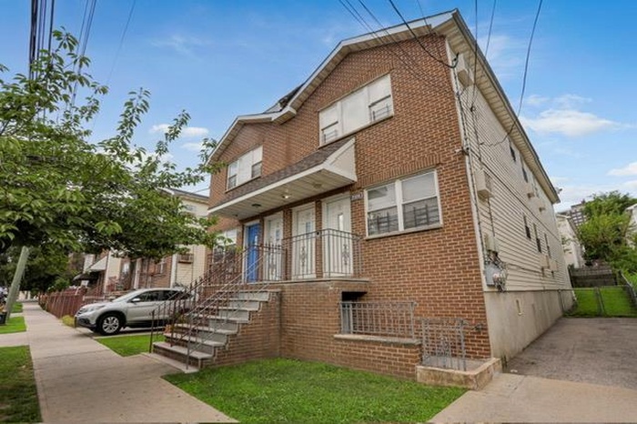 View of front facade with brick siding and stairway