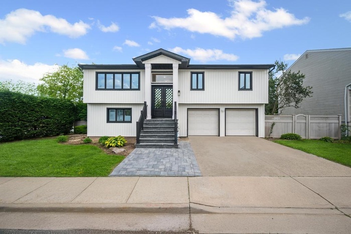 View of front facade with driveway and an attached garage