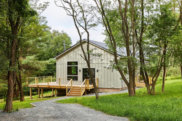 Modern inspired farmhouse featuring board and batten siding and a deck