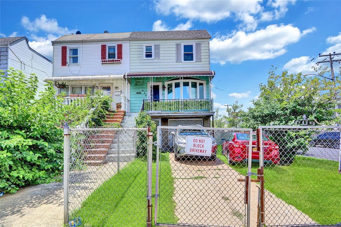 View of front of house featuring a gate, a fenced front yard, covered porch, and stairway