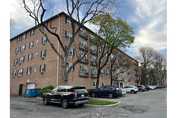 View of property with uncovered parking