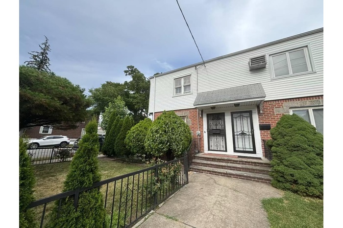 View of front of home featuring brick siding