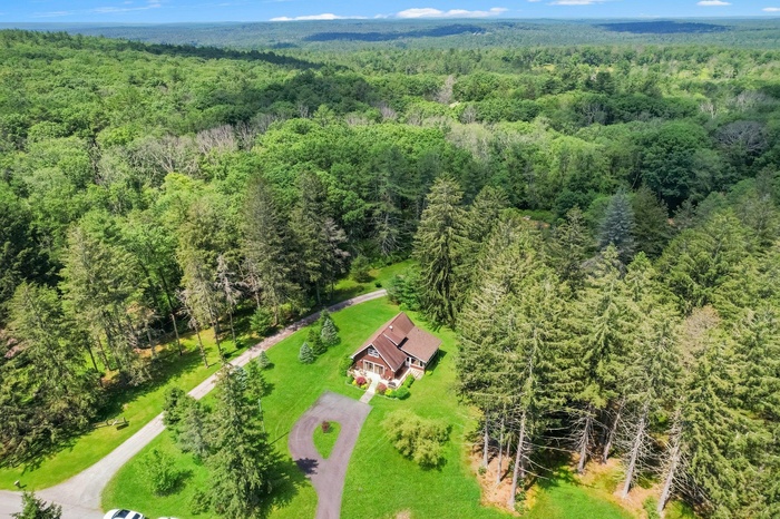 View from above of property with a forest