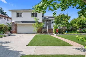 This house is located at the corner of a quiet tree lined road.
