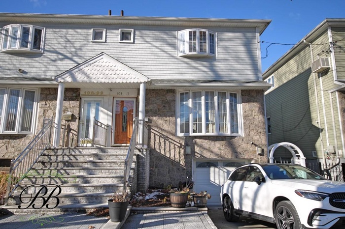 View of front of home with stone siding and cooling unit