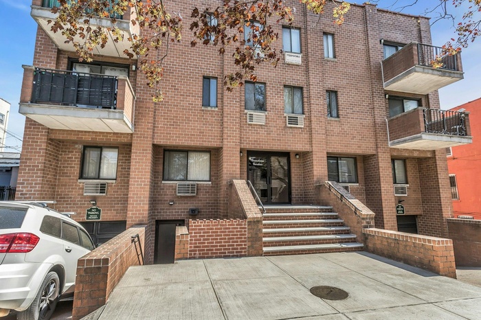 View of building exterior featuring cooling unit