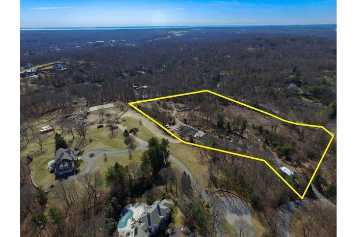 View of property location featuring property boundaries highlighted and a heavily wooded area