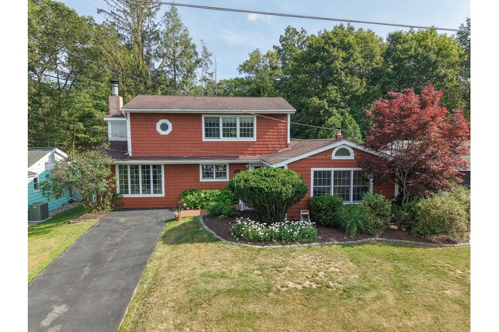 View of front of house with a front yard and a chimney