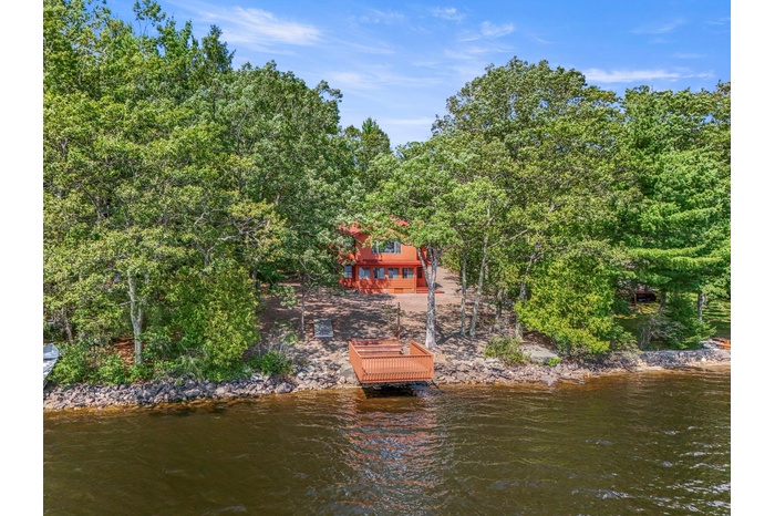 Dock area featuring a water view and a view of trees