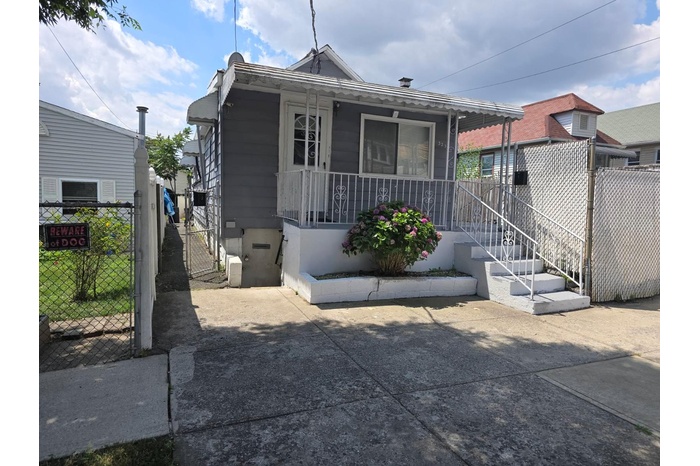 Rear view of house featuring a porch