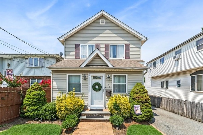 Traditional-style home featuring a shingled roof