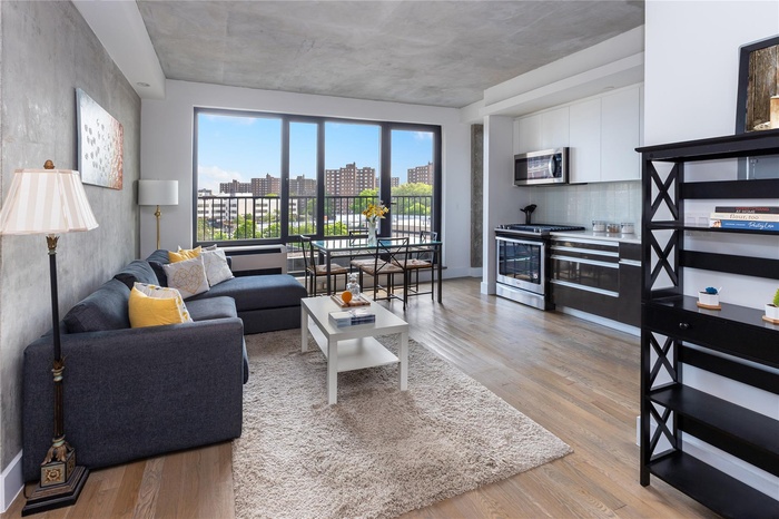 Living room with light wood finished floors and a view of city