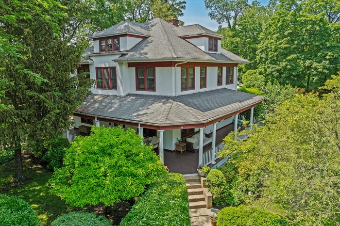 Craftsman house, shingled roof, covered porch, and stucco siding