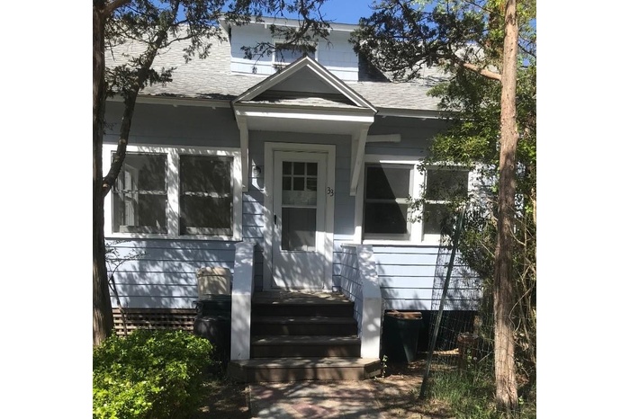 View of front of home featuring a shingled roof