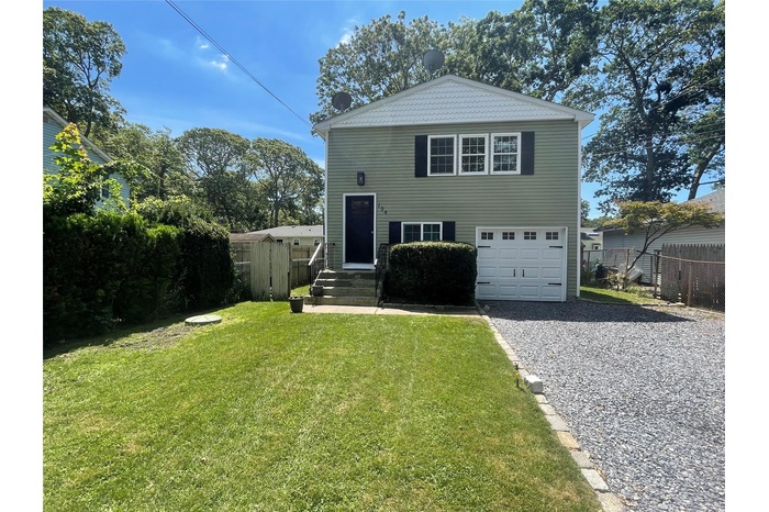 View of front of property with an attached garage and gravel driveway