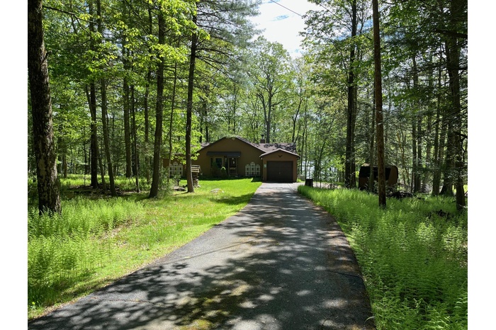 Welcome to this Lochada Lake home featuring approximately 200’ of lakefront with dock and raft!