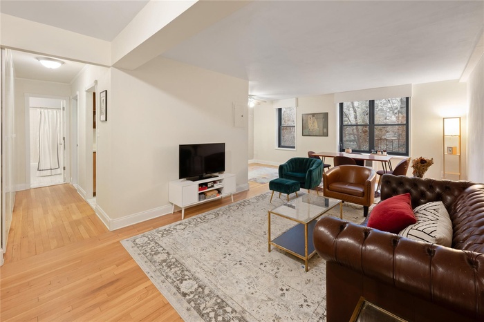 Living area featuring baseboards and light wood finished floors