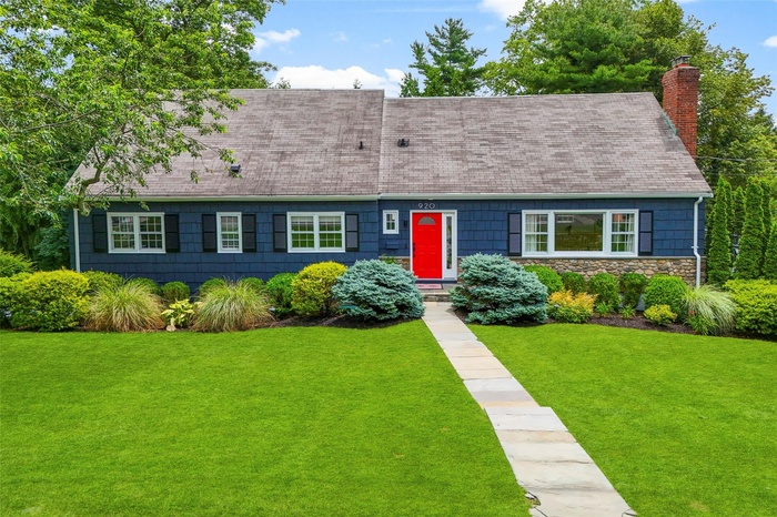 Front of home with mature landscaping